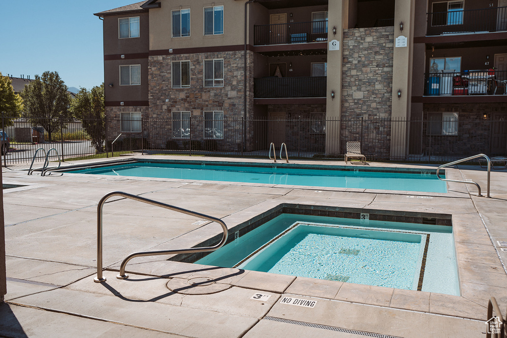 View of pool featuring a hot tub