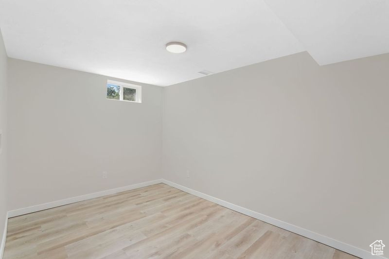 Laundry room with light hardwood / wood-style flooring