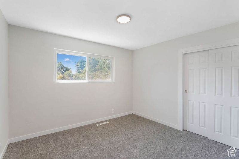 Unfurnished bedroom with a closet and carpet