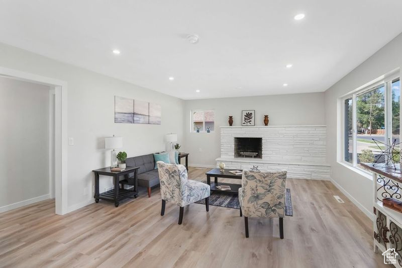 Interior space featuring light hardwood / wood-style flooring and a brick fireplace