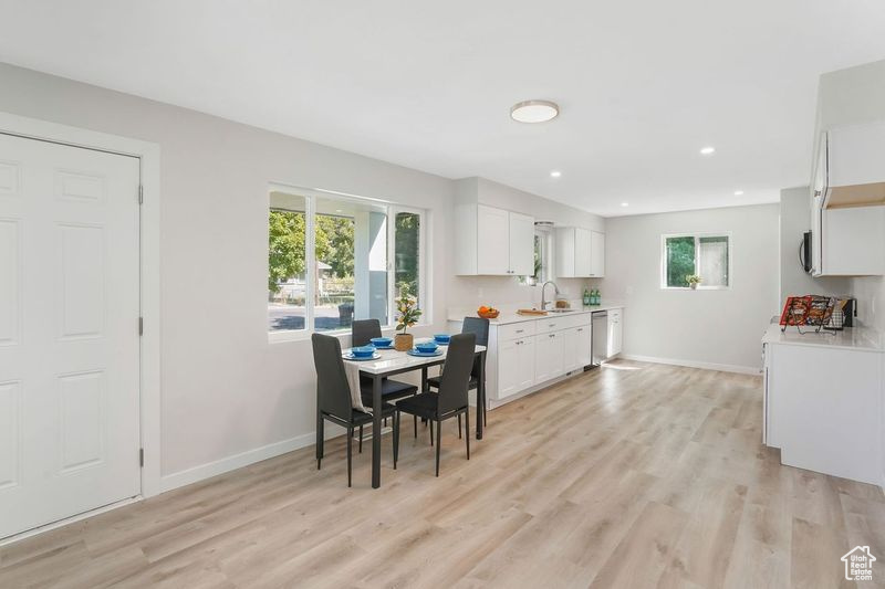 Dining room with sink and light hardwood / wood-style flooring