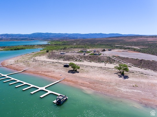 Birds eye view of property featuring a water and mountain view