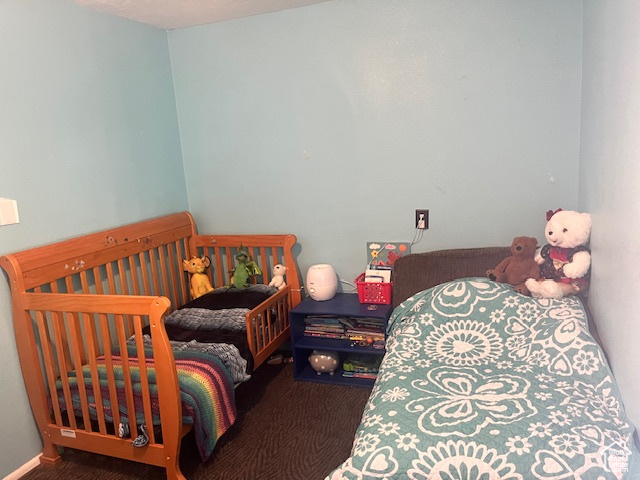 Carpeted bedroom with a crib