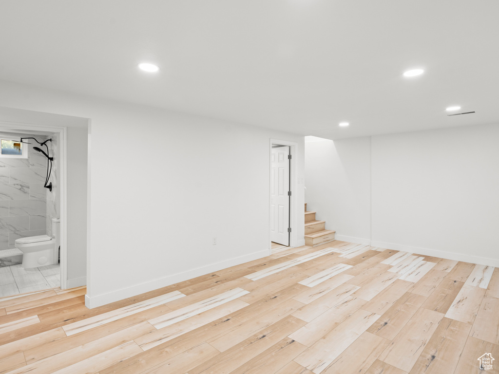 Basement with light wood-type flooring