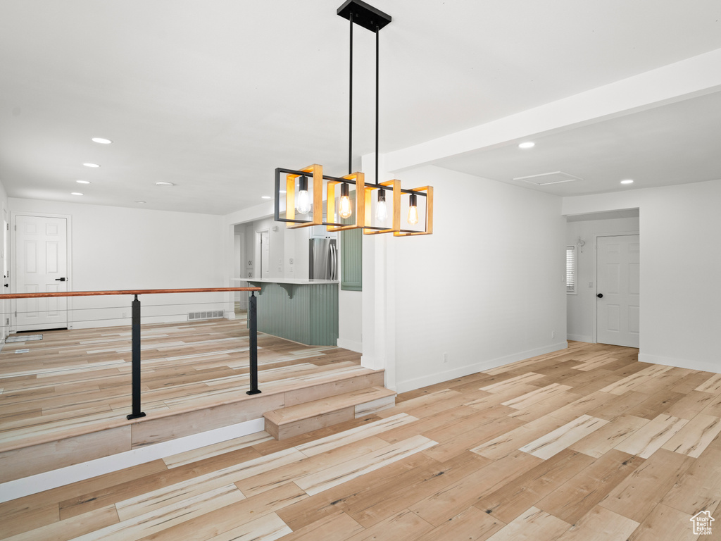 Unfurnished dining area with light wood-type flooring