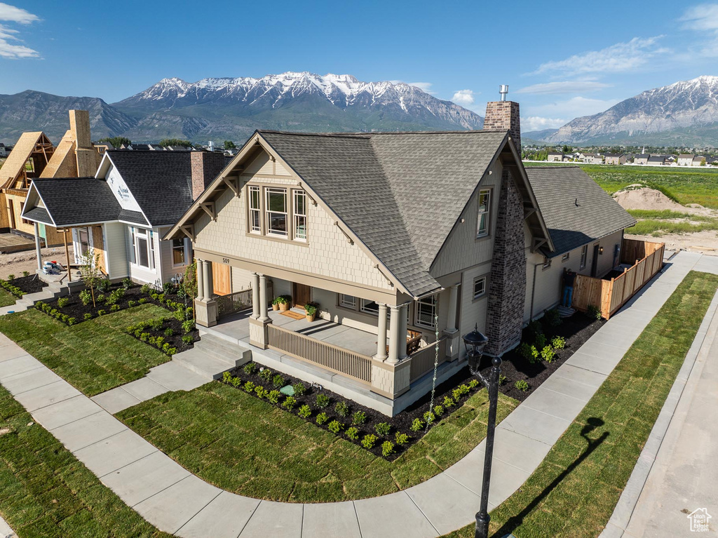 View of front facade featuring a front lawn and a mountain view