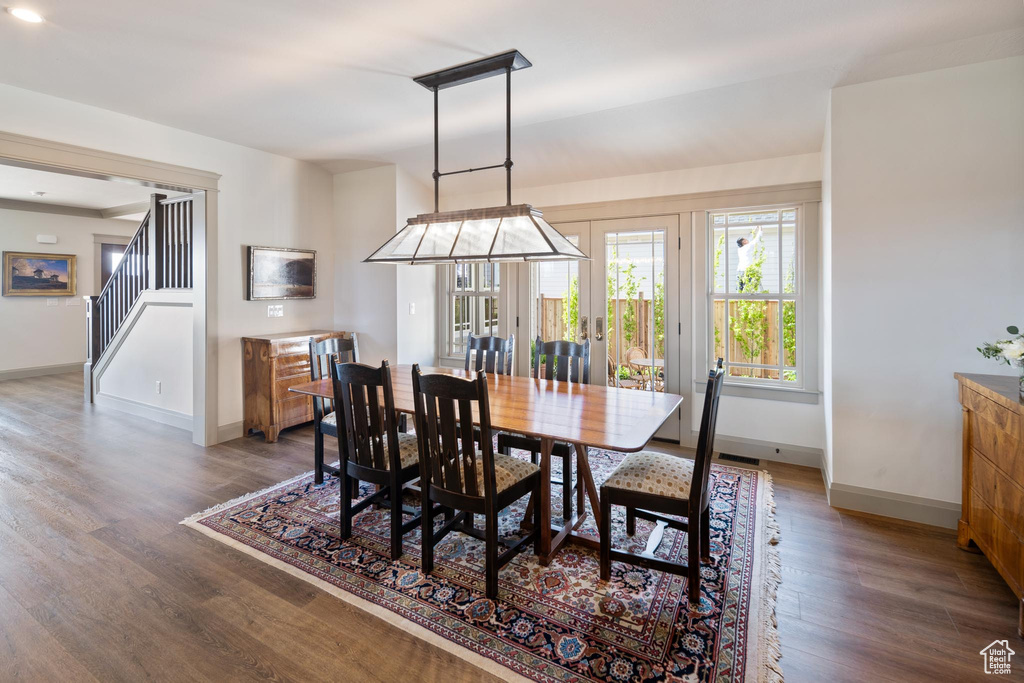 Dining space with hardwood / wood-style flooring