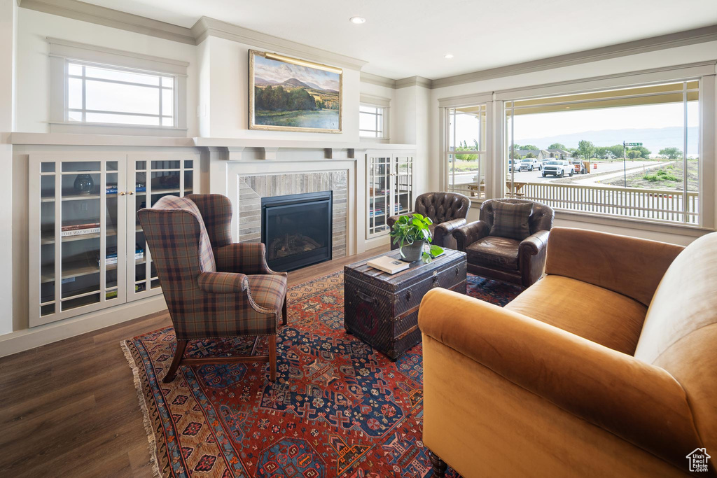 Living room featuring wood-type flooring and ornamental molding