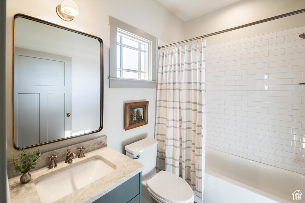 Full bathroom featuring shower / bath combo, toilet, and vanity