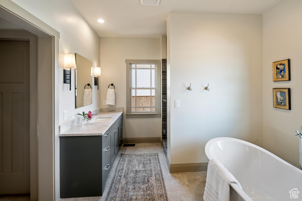 Bathroom featuring a bath and vanity