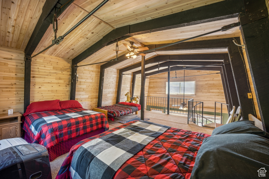 Bedroom featuring vaulted ceiling with beams, wood ceiling, and wooden walls