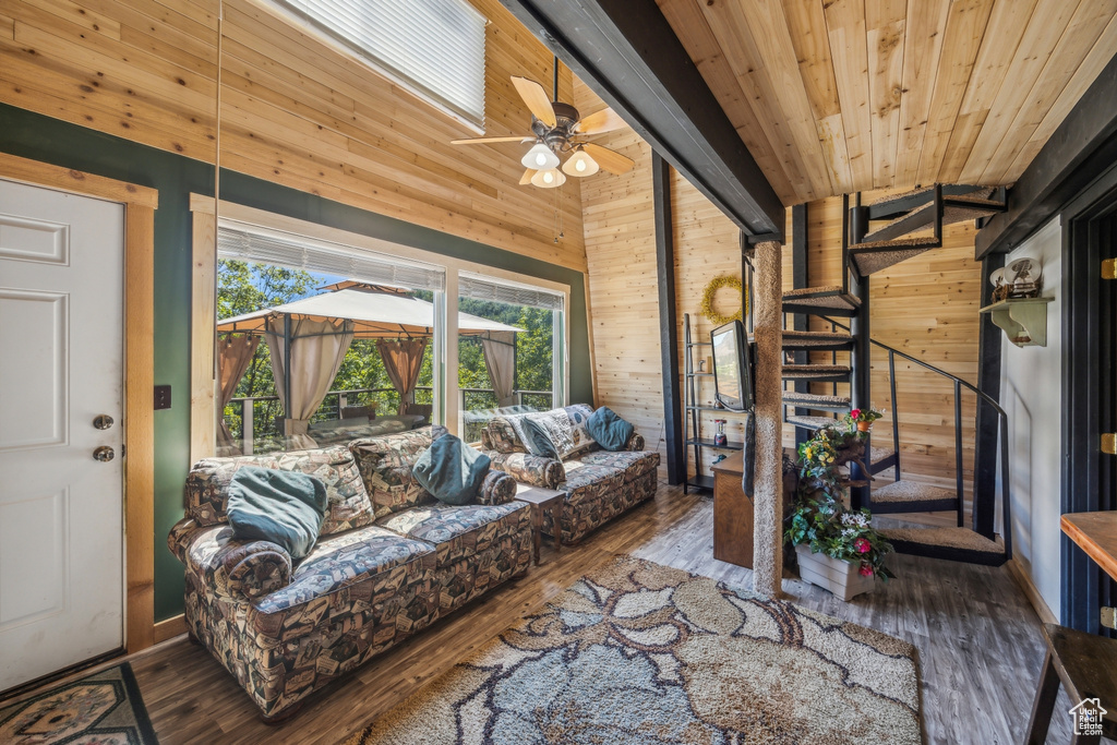 Sunroom featuring ceiling fan and wood ceiling