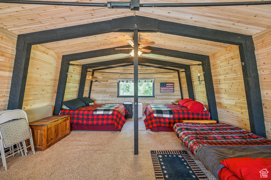 Bedroom with wooden walls, carpet floors, wooden ceiling, and lofted ceiling with beams