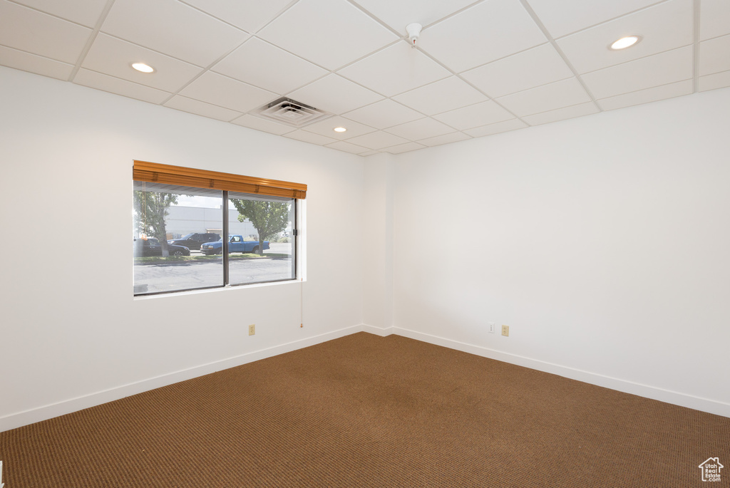 Unfurnished room featuring a paneled ceiling and carpet flooring