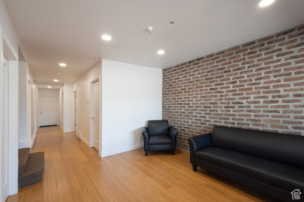 Living area featuring light hardwood / wood-style floors and brick wall