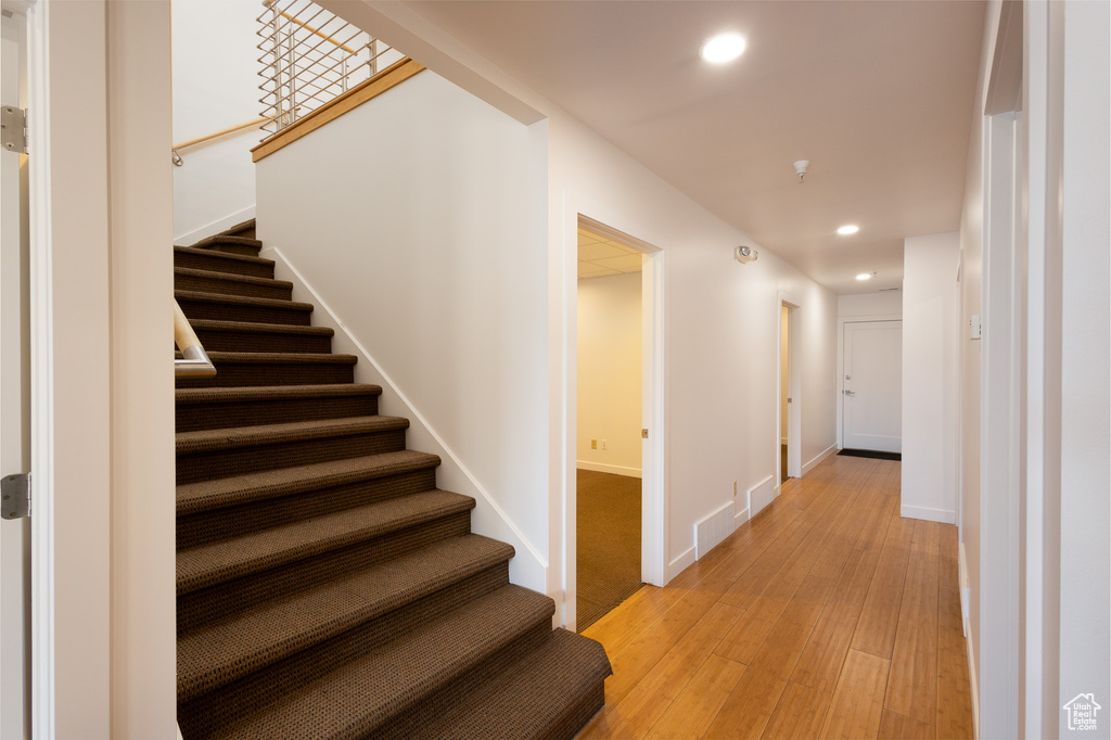 Stairway with hardwood / wood-style flooring