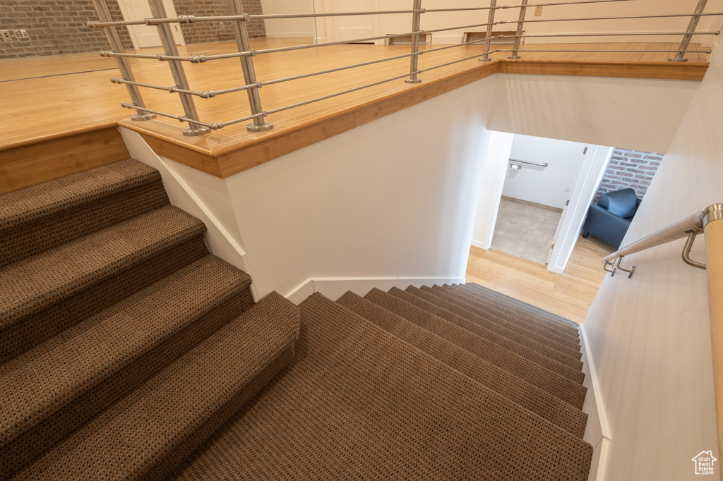 Stairs with hardwood / wood-style flooring