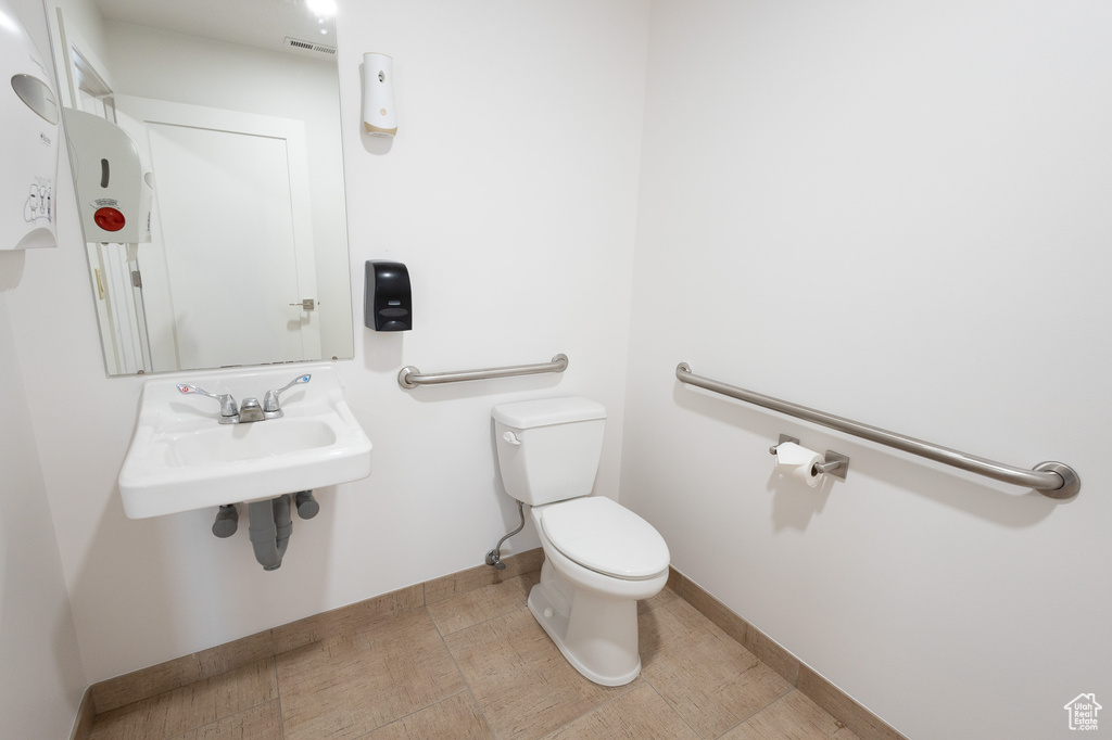 Bathroom with sink, toilet, and tile patterned flooring