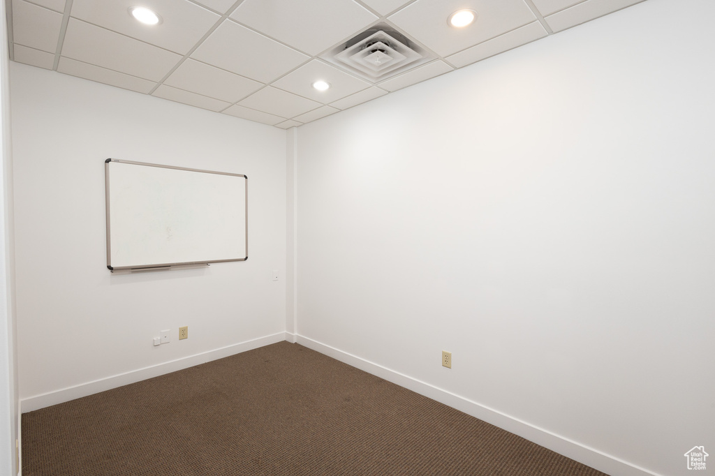 Carpeted empty room with a paneled ceiling