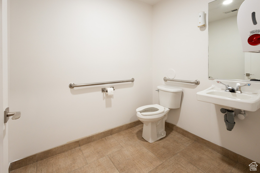 Bathroom with sink, toilet, and tile patterned floors