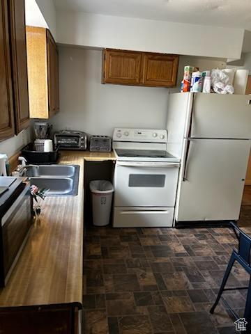 Kitchen with sink and white appliances