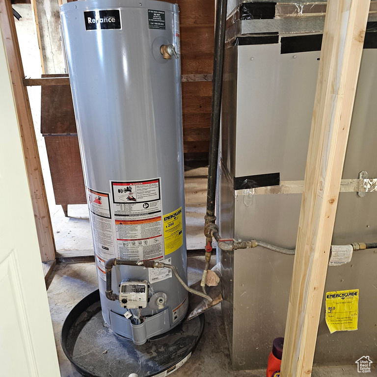 Utility room with gas water heater and heating unit