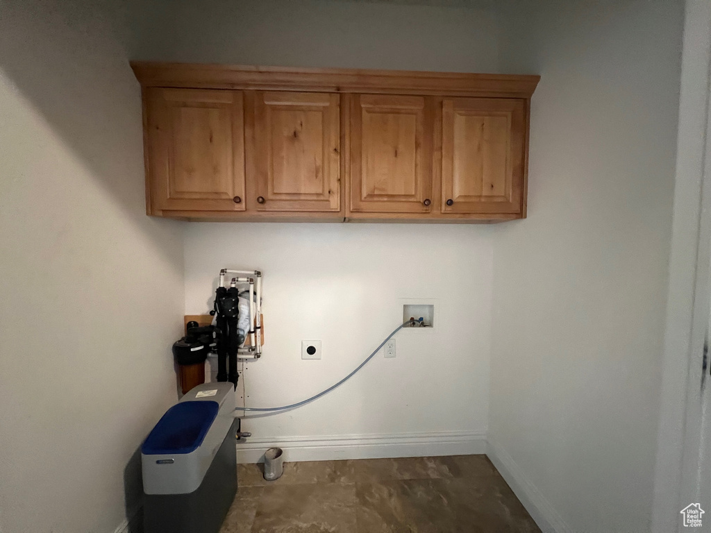 Clothes washing area featuring washer hookup, cabinets, and electric dryer hookup