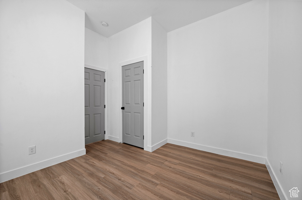 Unfurnished bedroom with wood-type flooring