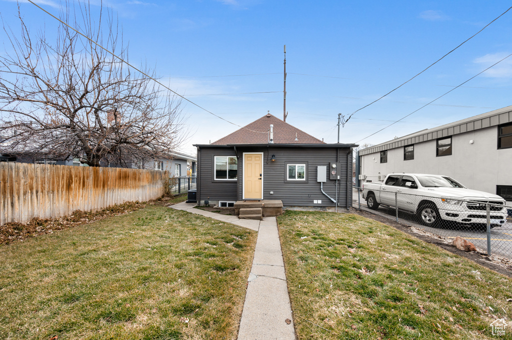 Bungalow-style home with a front lawn