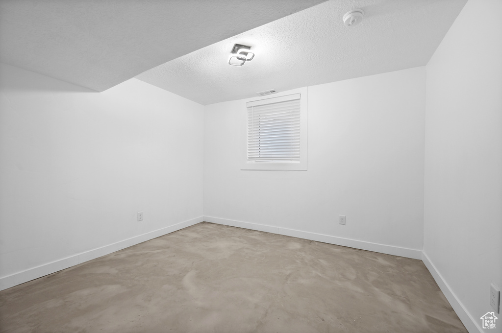 Empty room featuring a textured ceiling