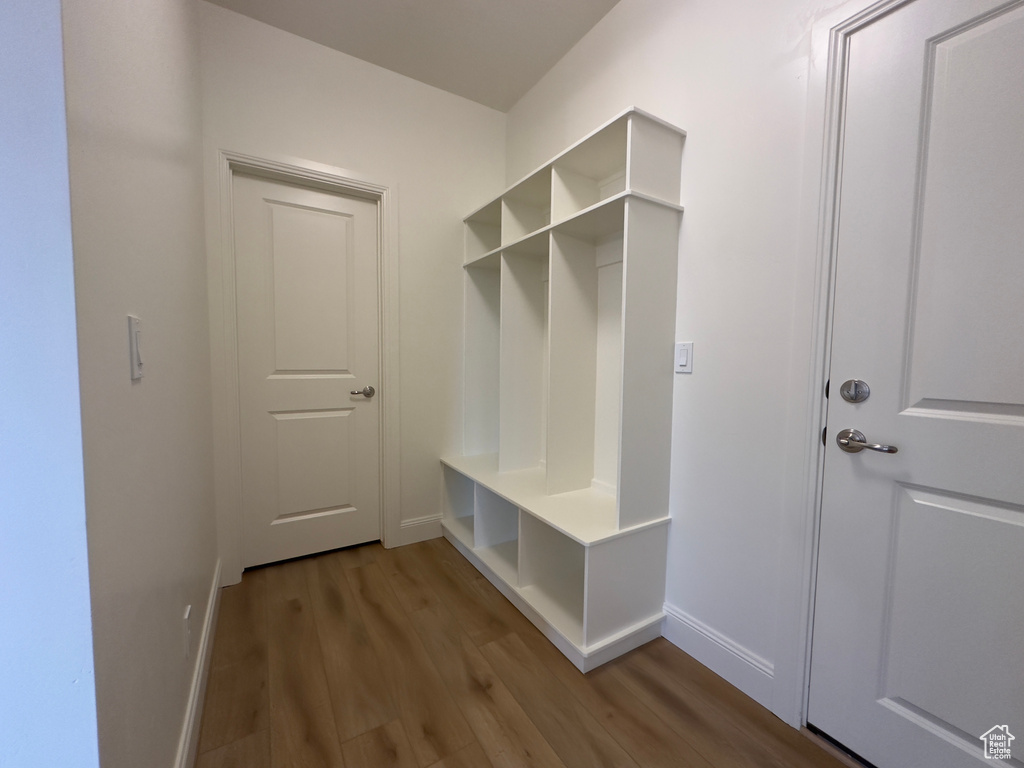 Mudroom featuring wood finished floors and baseboards