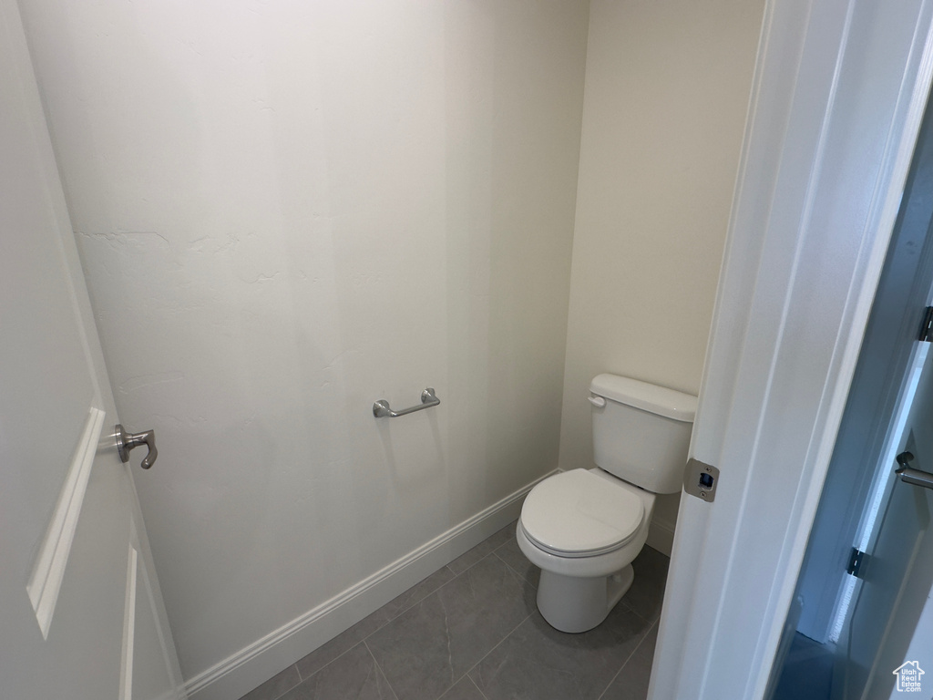Bathroom with toilet and tile patterned floors