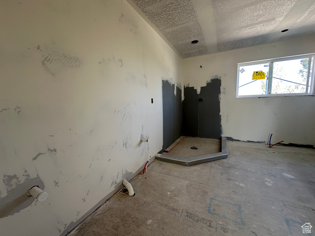 Unfurnished room featuring a textured ceiling