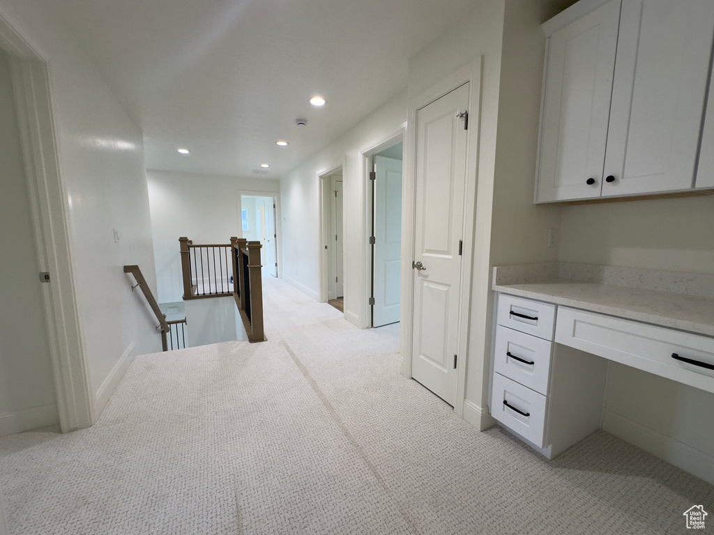 Hall featuring an upstairs landing, light carpet, recessed lighting, and baseboards