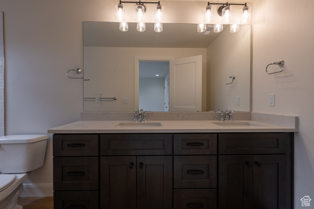 Full bath with toilet and double vanity