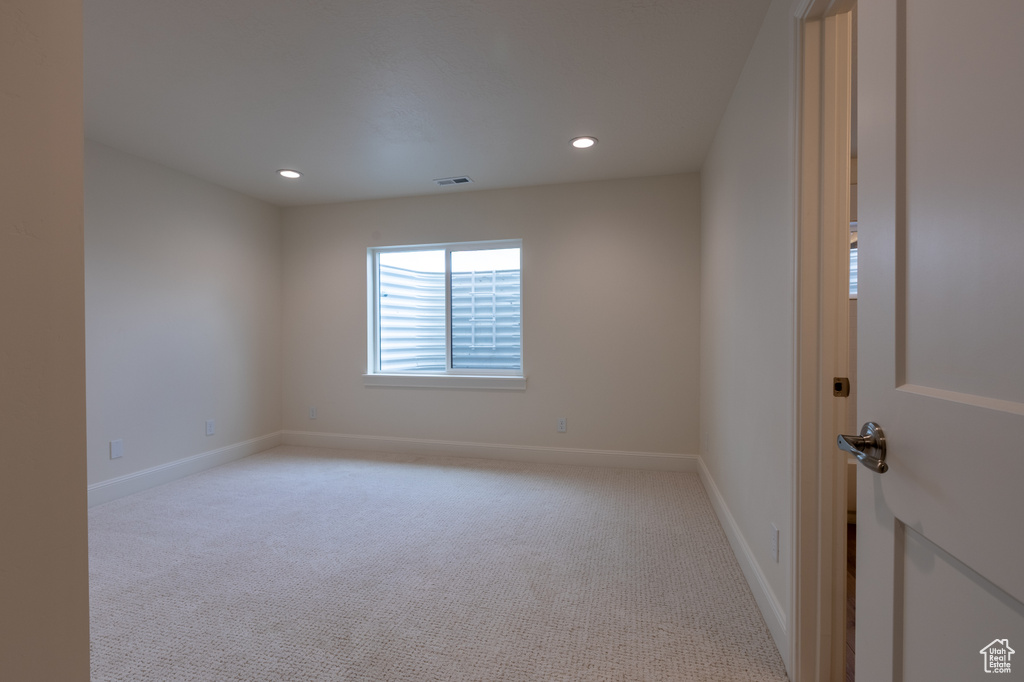 Empty room with recessed lighting, light carpet, and baseboards