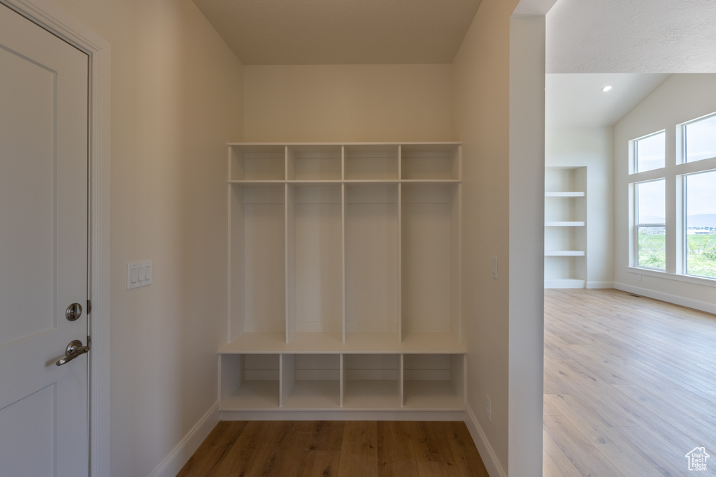 Mudroom with wood finished floors and baseboards