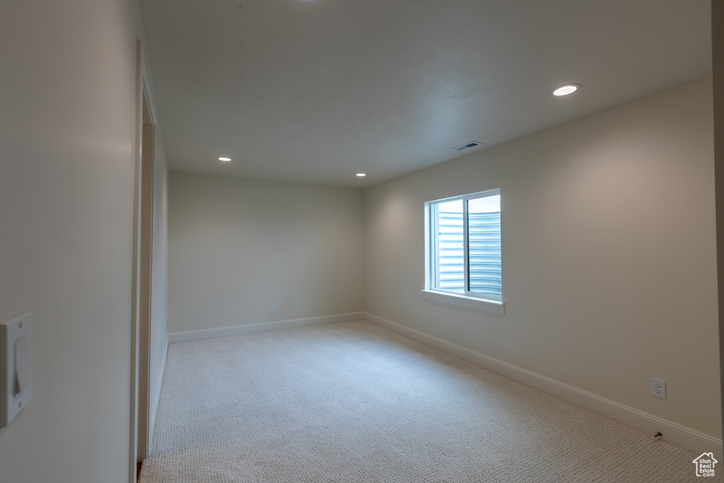 Empty room featuring recessed lighting, carpet floors, and baseboards