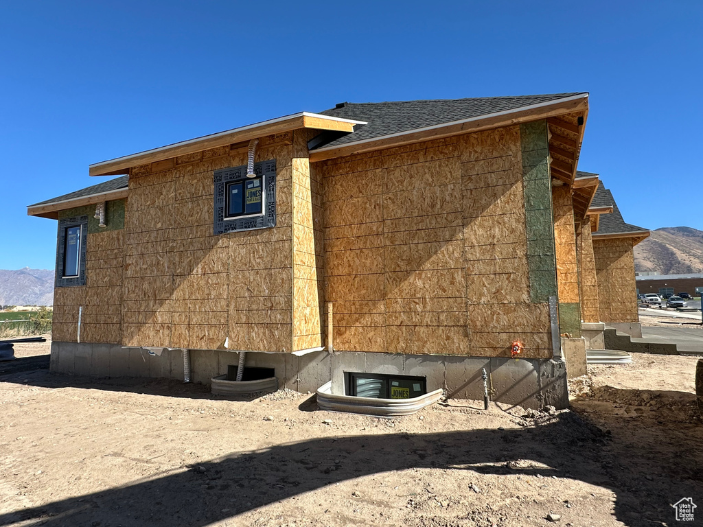 View of side of home with a mountain view