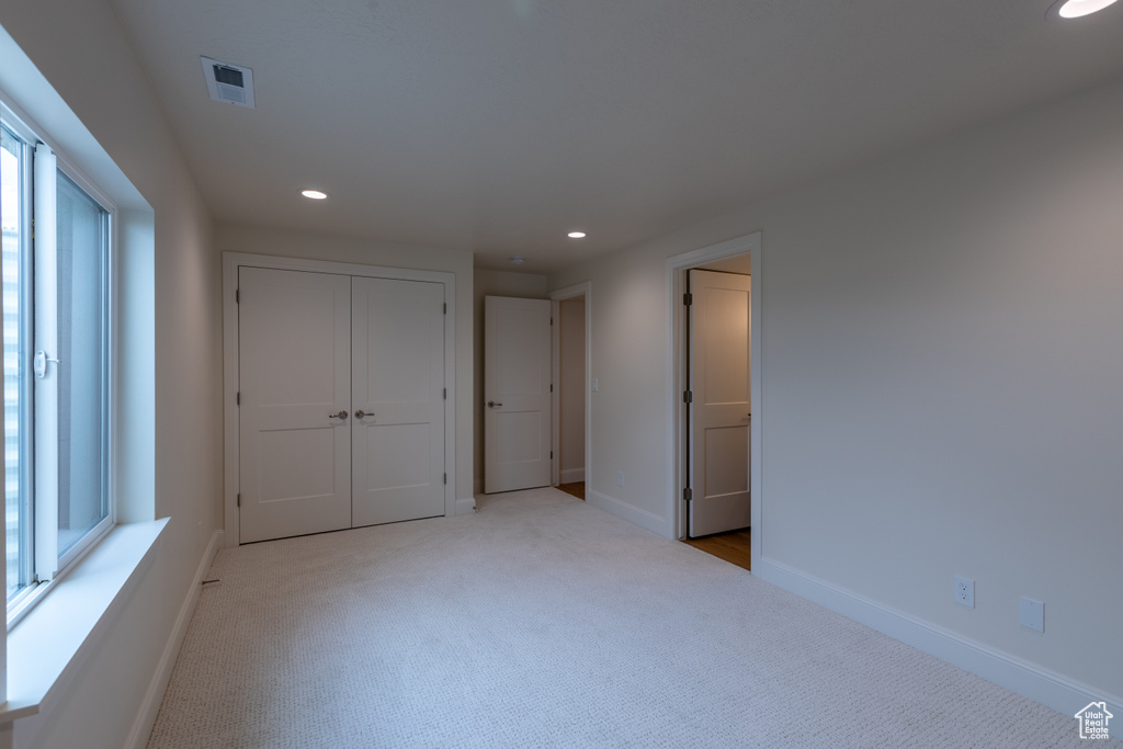 Unfurnished bedroom featuring carpet, recessed lighting, baseboards, and a closet
