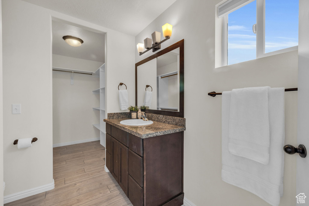 Bathroom featuring hardwood / wood-style flooring and vanity