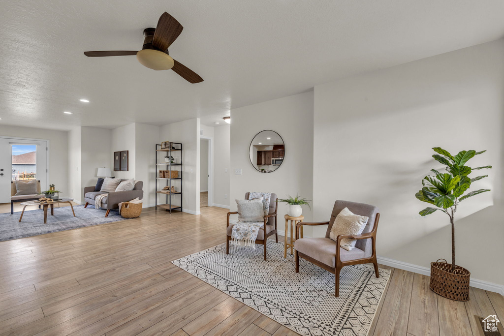 Sitting room featuring light wood-type flooring and ceiling fan