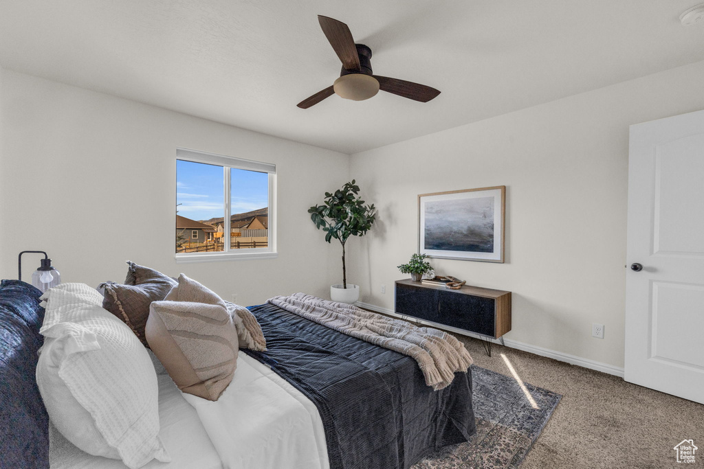 Carpeted bedroom with ceiling fan