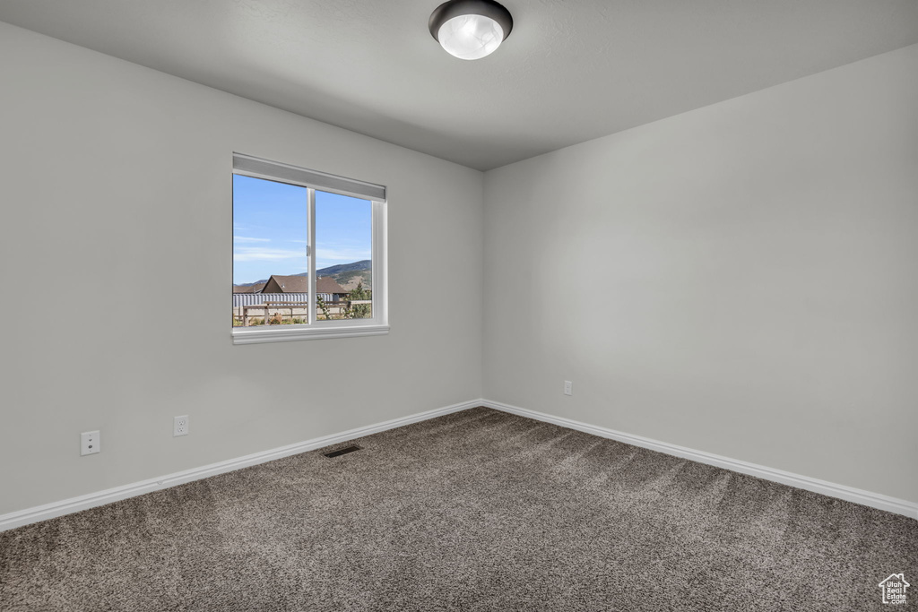 Unfurnished room with carpet floors