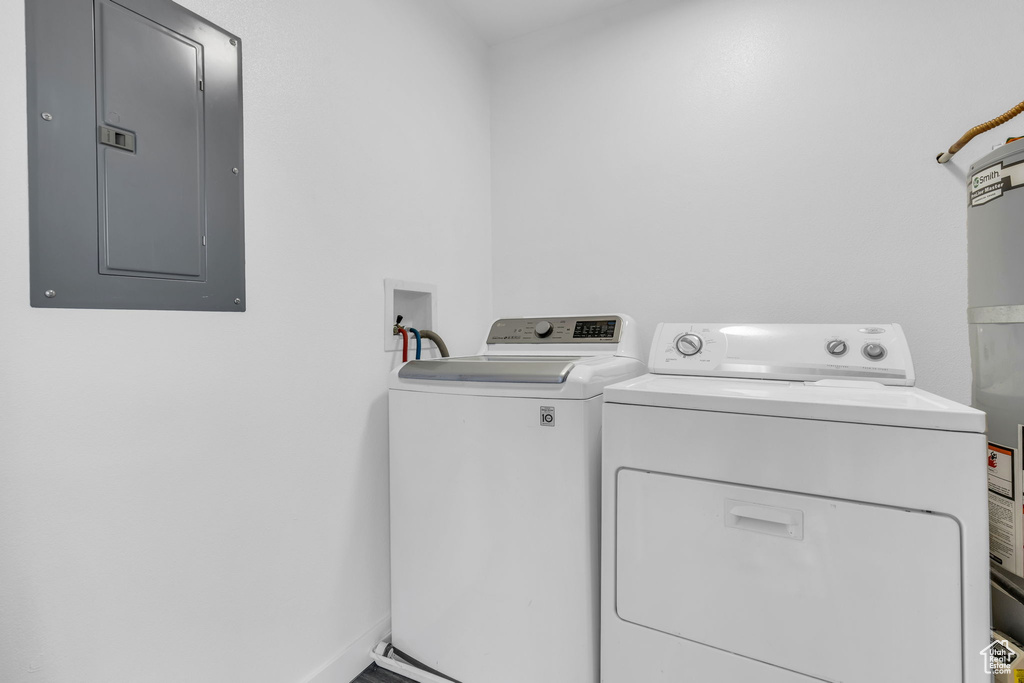 Clothes washing area featuring washer and dryer and electric panel