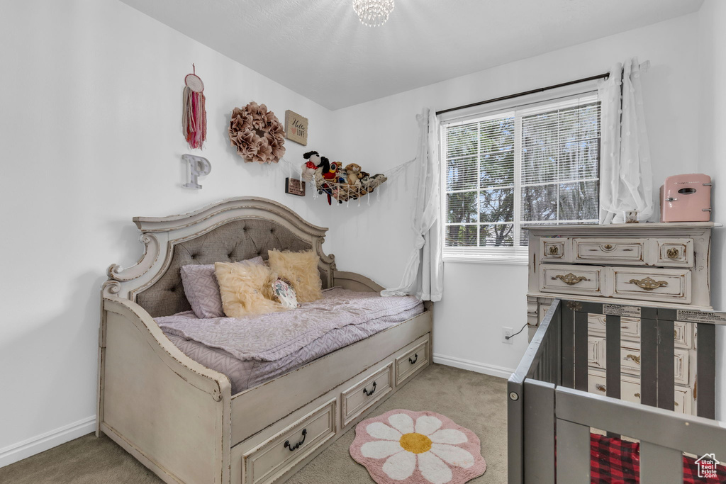 Bedroom featuring light carpet