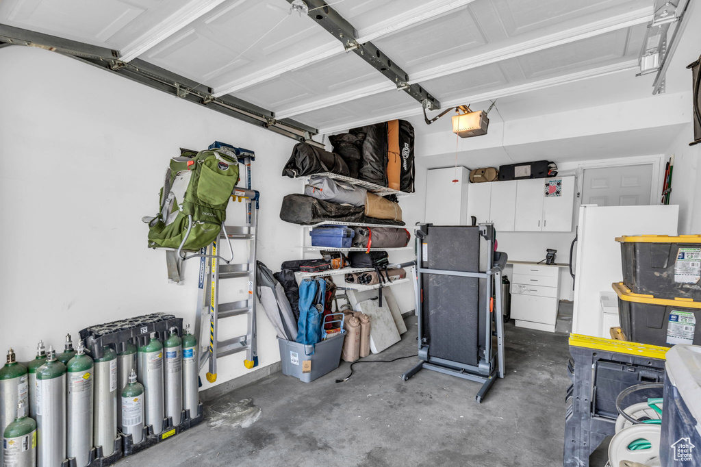 Garage with a garage door opener and fridge