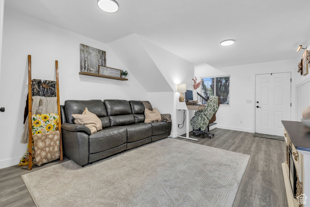 Living room with hardwood / wood-style floors and vaulted ceiling