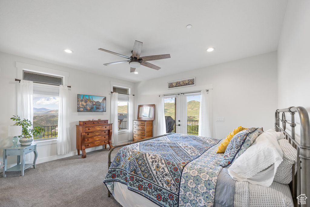 Carpeted bedroom with ceiling fan, access to outside, and french doors