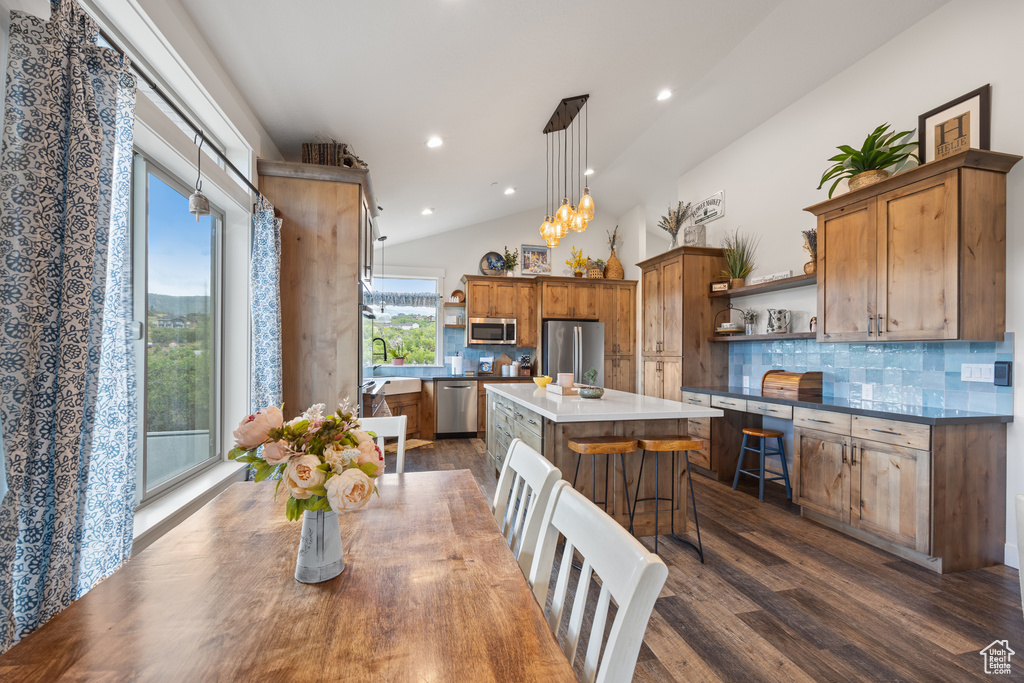 Interior space with dark hardwood / wood-style flooring, lofted ceiling, and a chandelier